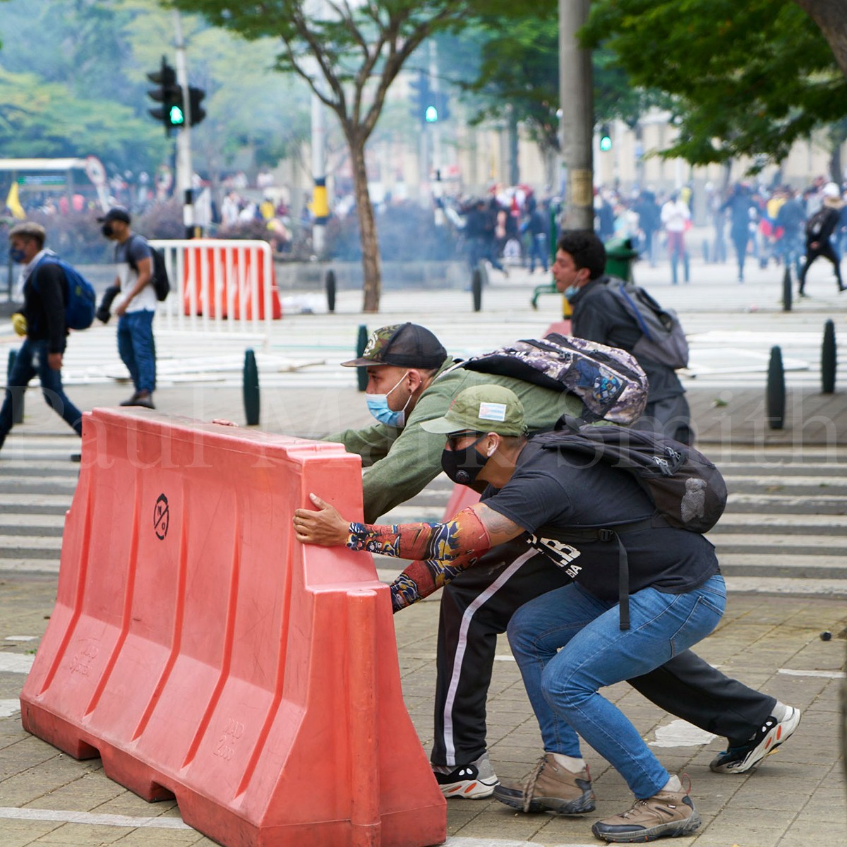 Protester move road barriers as they battle with police