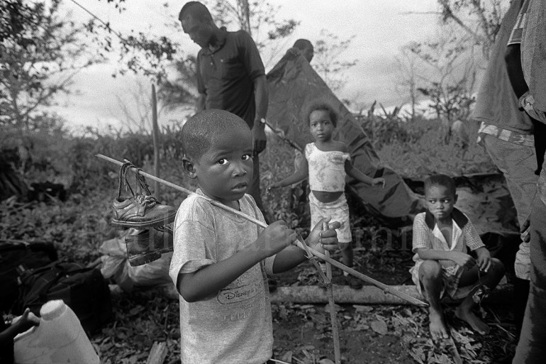 Children wait on the river's edge