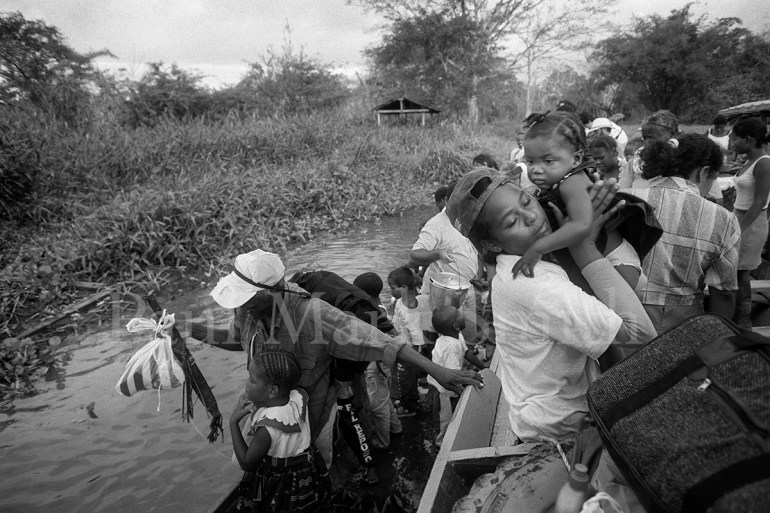 A boat arrives and the passengers prepare to disembark