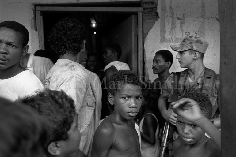 soldier and displaced people gathered