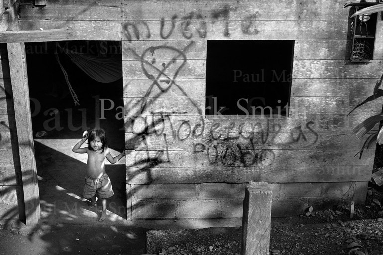 Young girl and paramilitary skull and crossbones and death graffiti