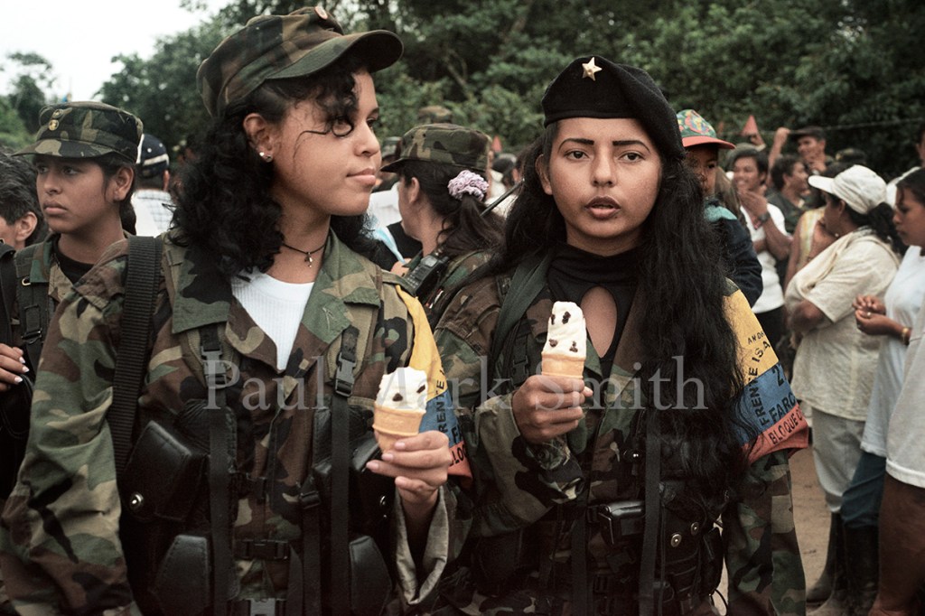 Two girl guerrillas stroll and eat ice cream