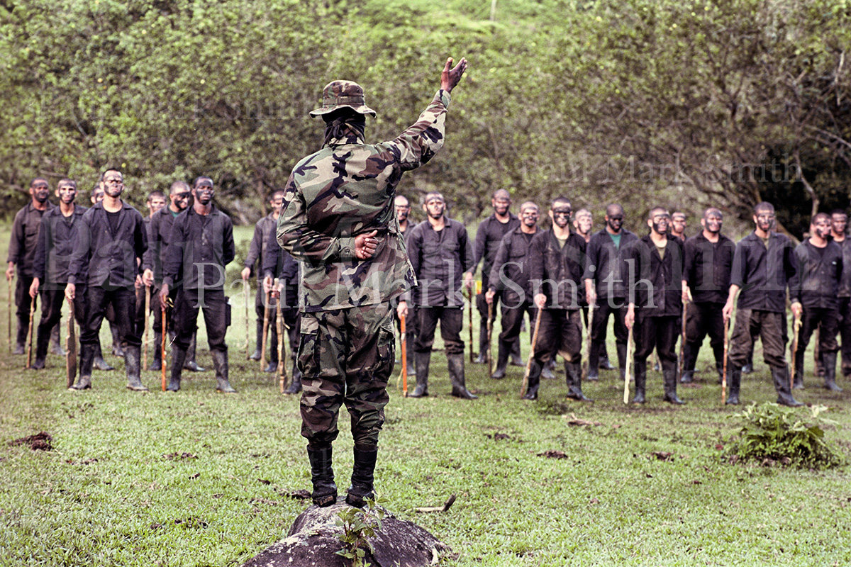 Youths train with wooden weapons in paramilitary encampment of the Metro Block