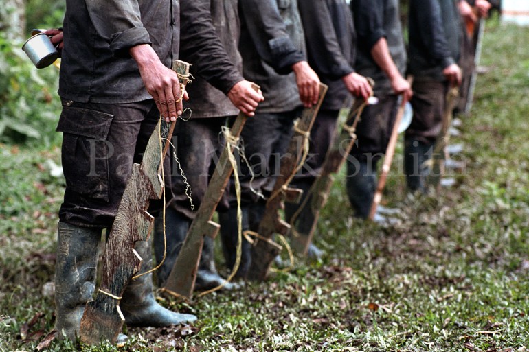 Youths train with wooden weapons in paramilitary encampment of the Metro Block