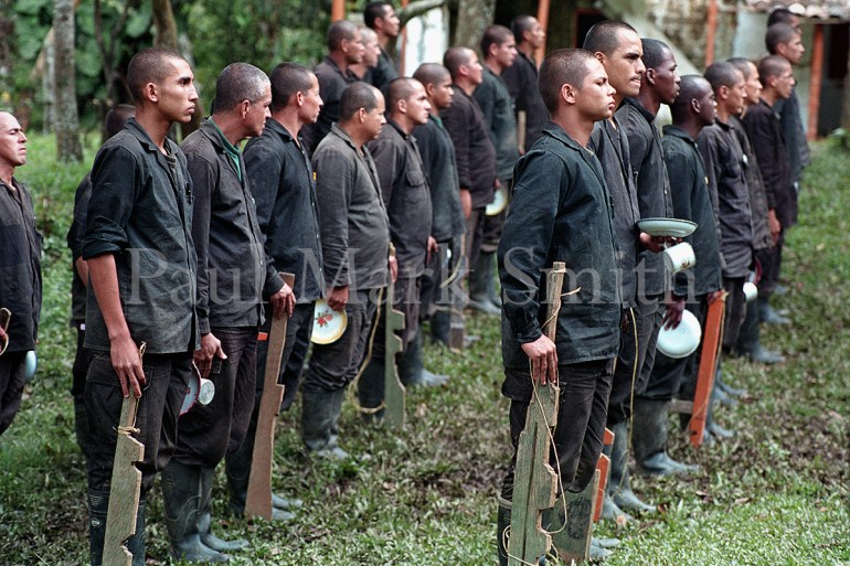 Youths train with wooden weapons in paramilitary encampment of the Metro Block