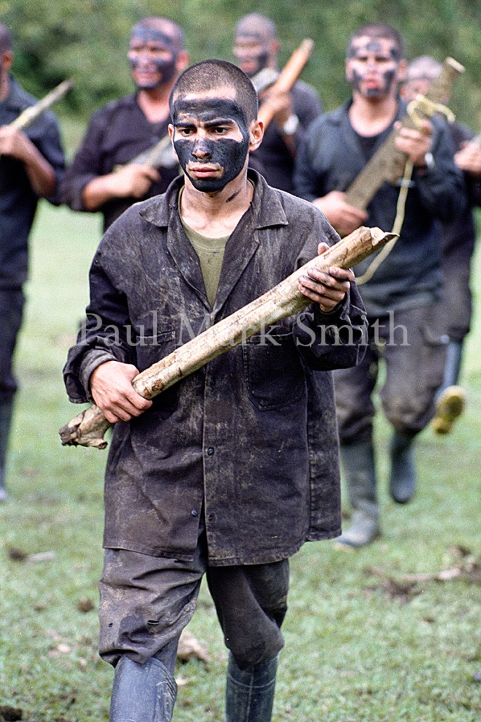 Youths train with wooden weapons in paramilitary encampment of the Metro Block