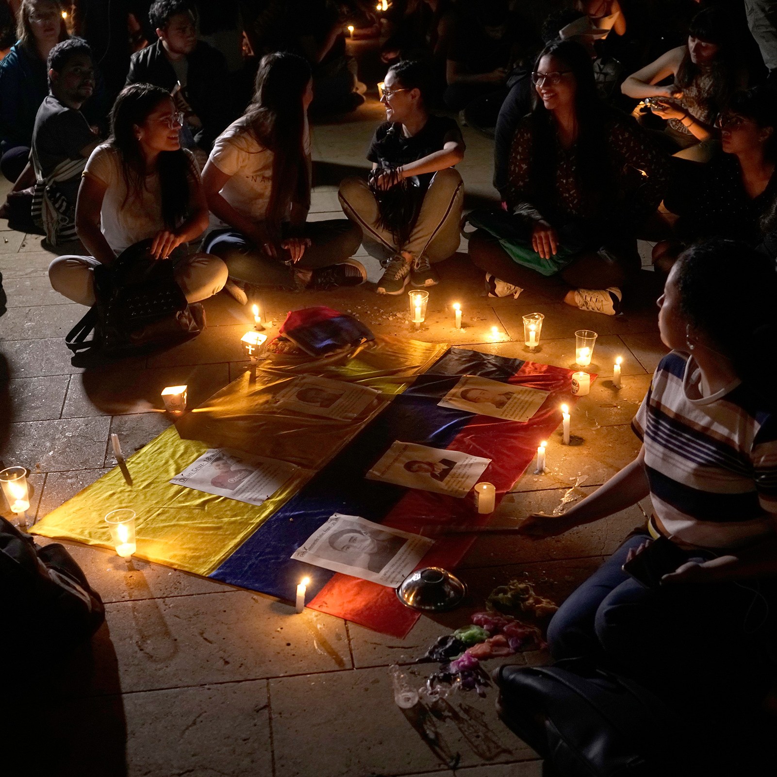 Burning candles on a Colombian flag to protest police violence
