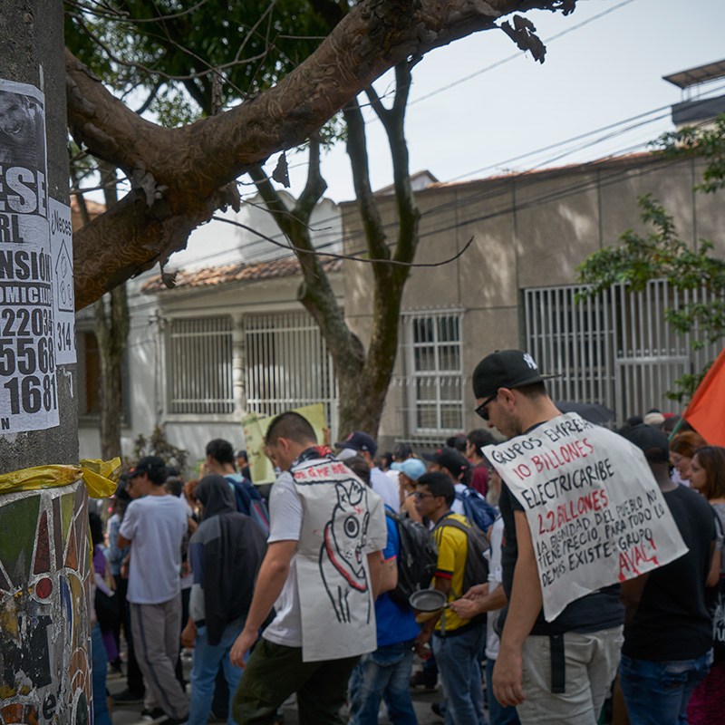Placards protest government policies and poster advertising pension and health payments for independent workers