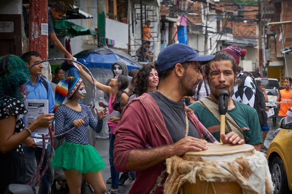 A band and performers on the street in an urban neighbourhood