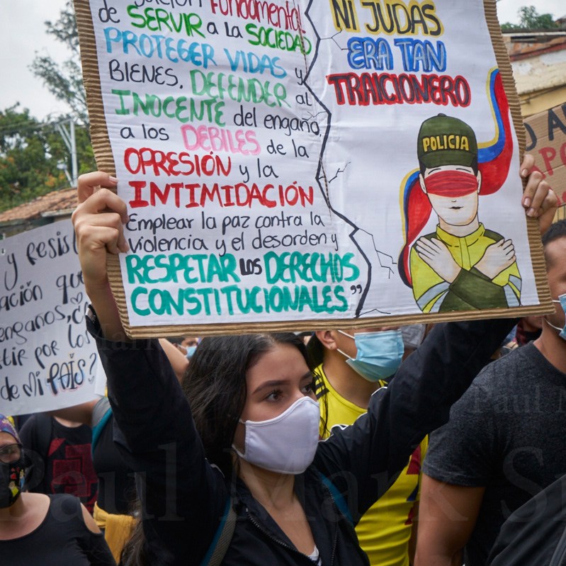 Young woman holds placard with message for the police