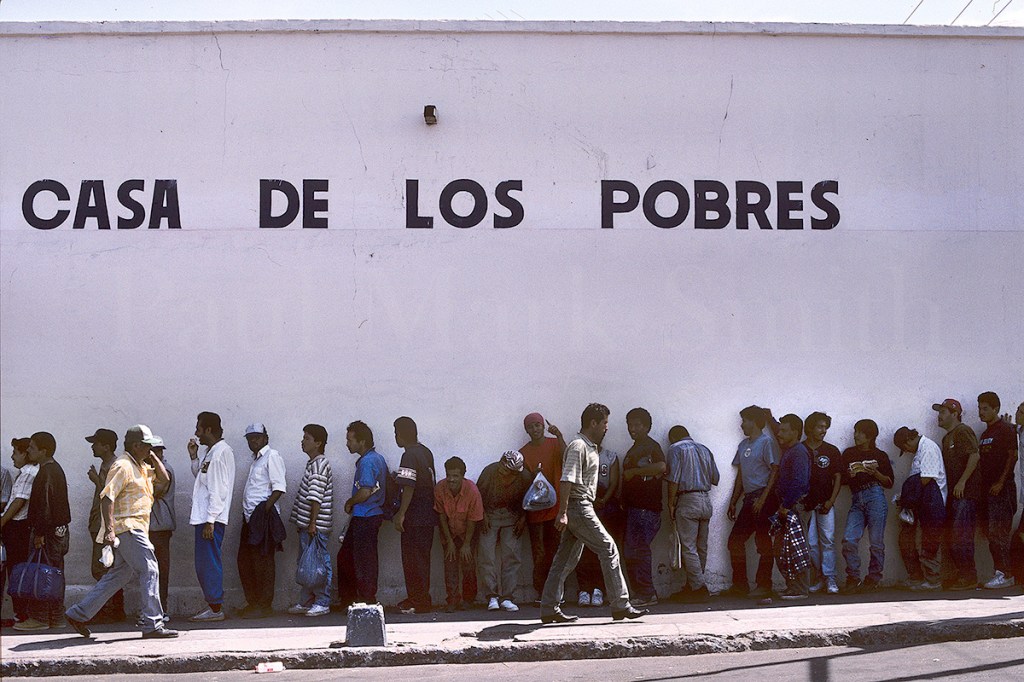 Long line of men waiting to receive a meal
