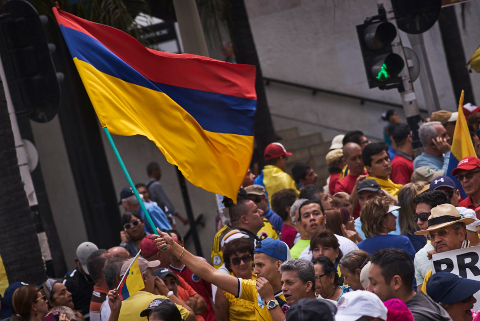 Man with upside down Colombian flag in a protest
